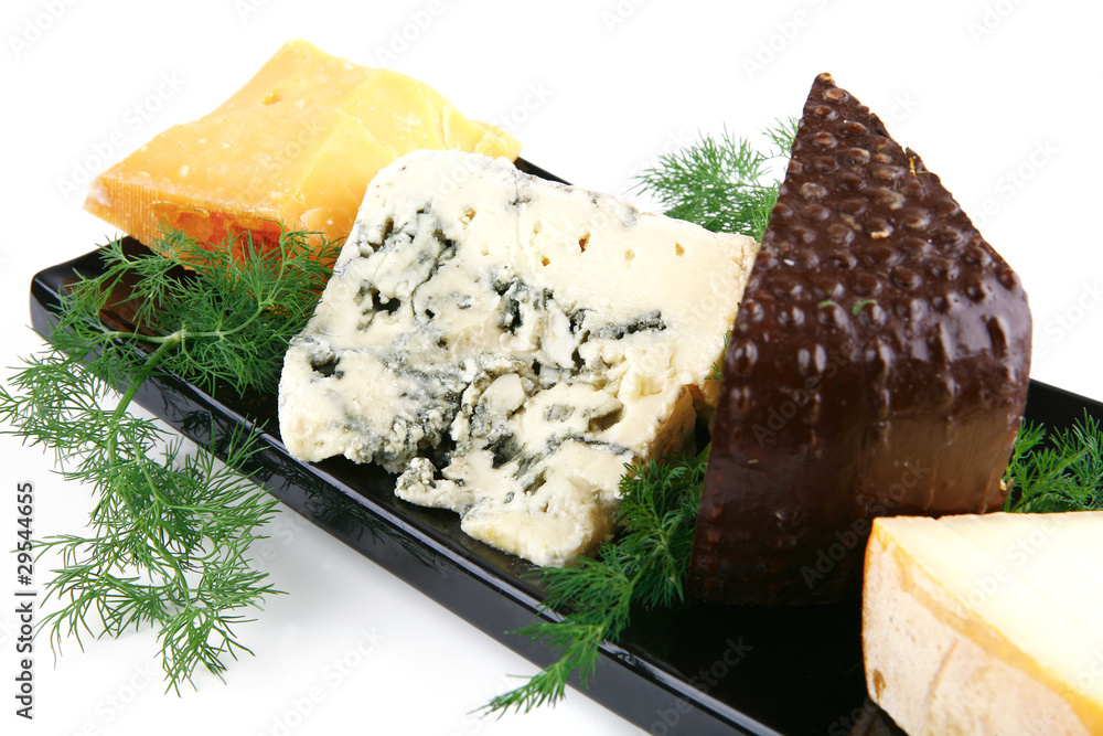 aged cheeses on black plate