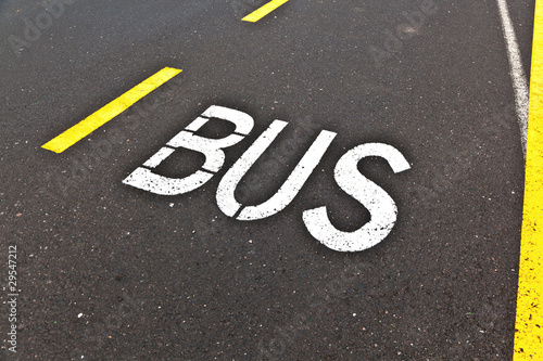 signs for bus are painted on the street
