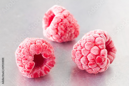 Delicious frozen raspberries on steel