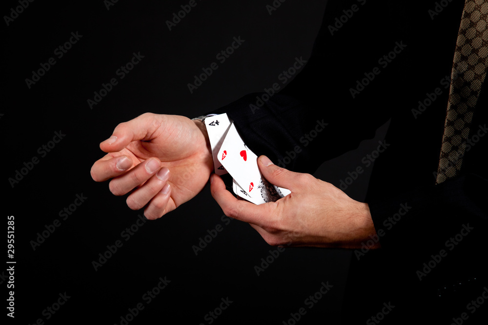 Fototapeta premium Ace up the sleeve. Gambling, isolated on black