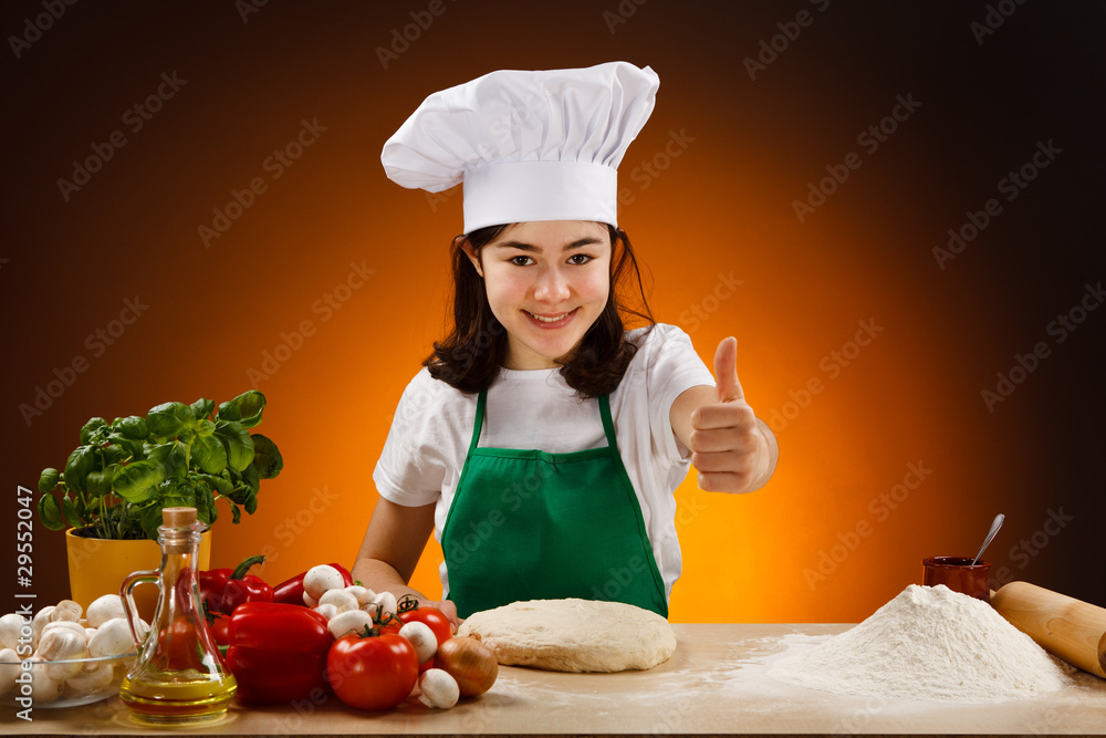 Girl making pizza dough showing ok sign Girl making pizza dough showing ok sign