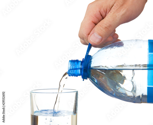 pouring water from a bottle into a glass