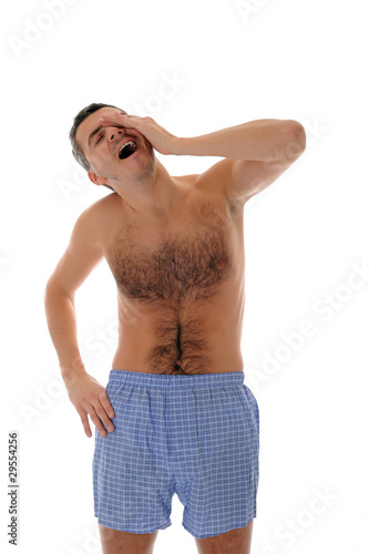 Cuadro en lienzo Young handsome man in underware waking up in the morning and yaw