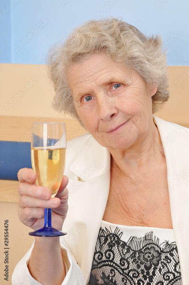 senior lady with goblet of champagne senior lady with goblet of champagne