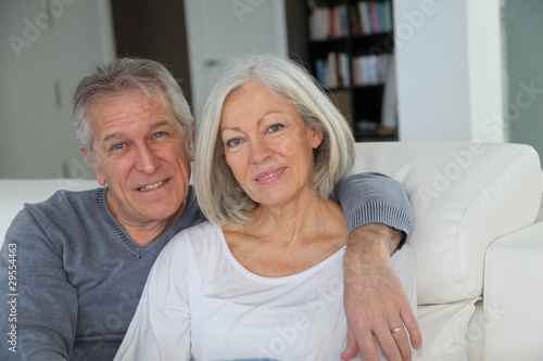 Senior couple sitting in sofa at home