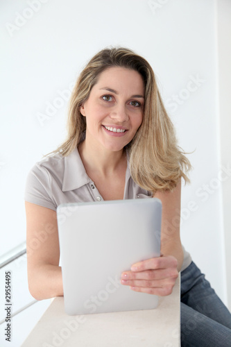 Woman using electronic tablet at home