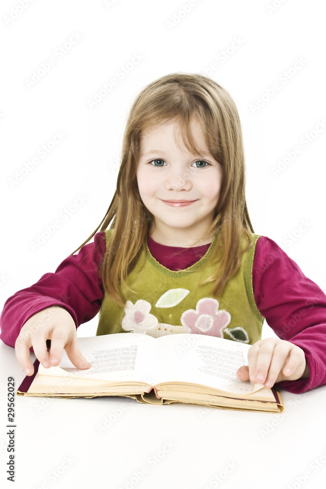 Beautiful young girl sitting at the desk and reading book. Beautiful young girl sitting at the desk and reading book.