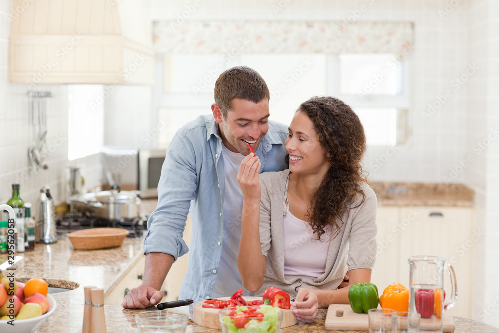Man eating vegetables with his wife Man eating vegetables with his wife