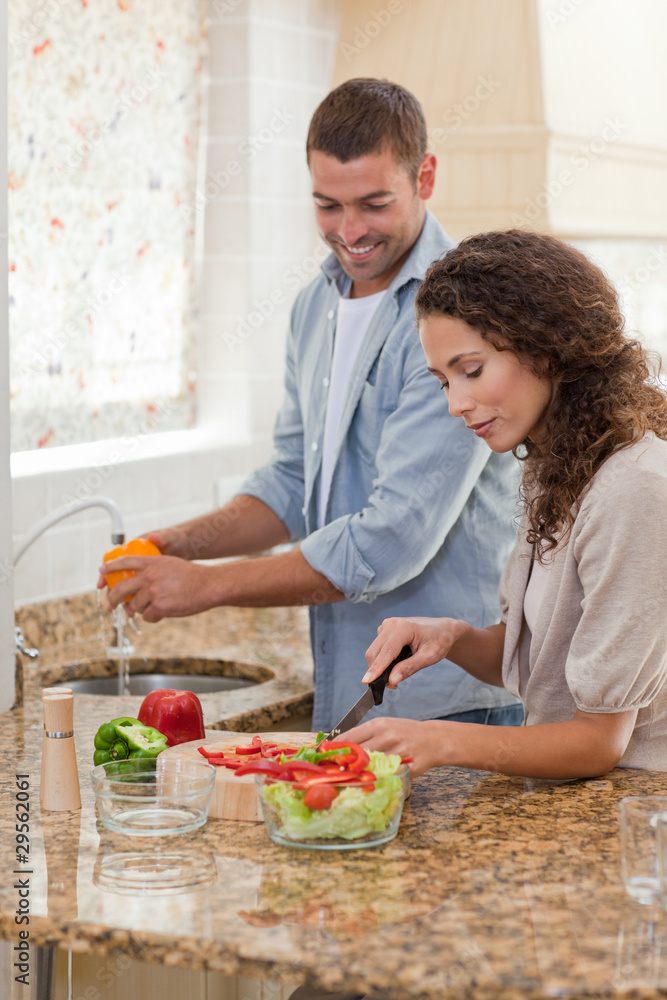 Handsome man cooking with his girlfriend Handsome man cooking with his girlfriend