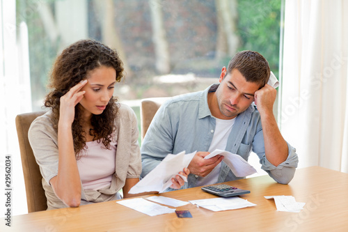 Young couple calculating their domestic bills photo