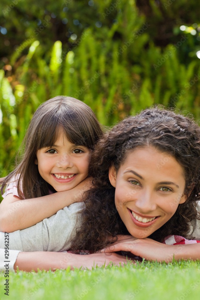 Adorable mother with her daughter in the garden Adorable mother with her daughter in the garden
