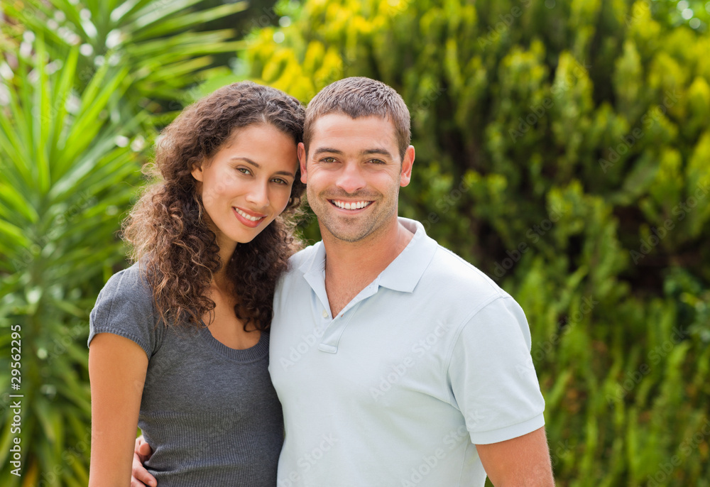 Happy couple hugging in the garden