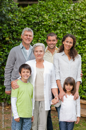 Portrait of a happy family looking at the camera in the garden