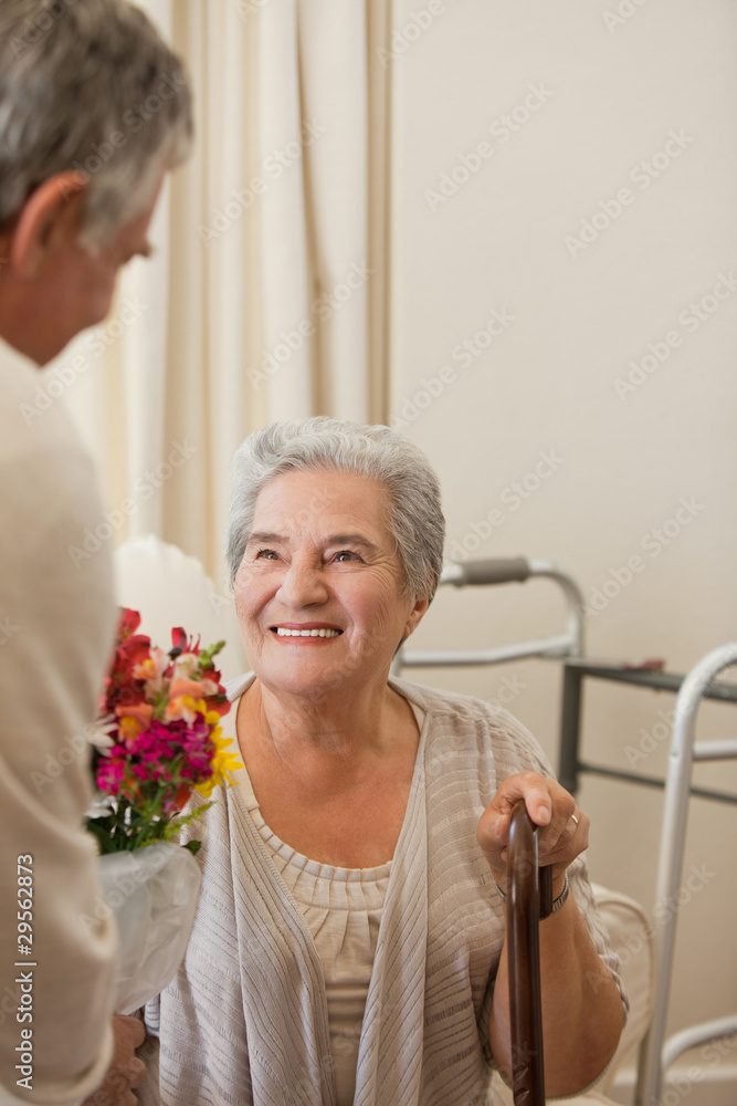 Retired man offering flowers to his wife Retired man offering flowers to his wife