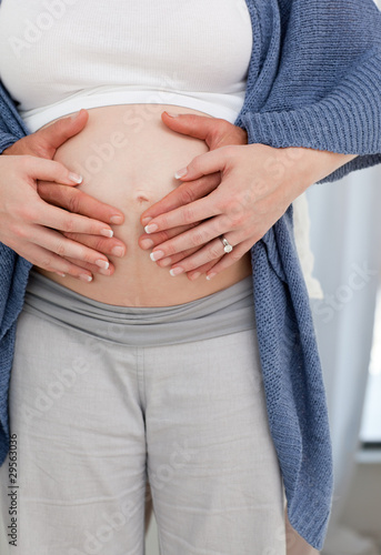 Couple's hand on the belly of the pregnant woman