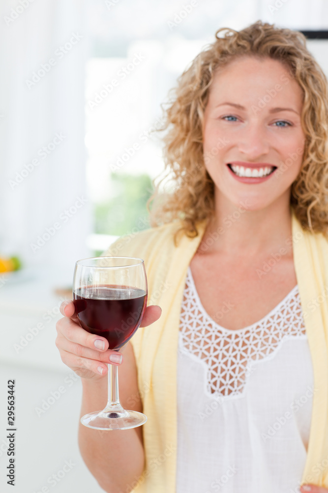 Woman looking at the camera with her drink of wine Woman looking at the camera with her drink of wine