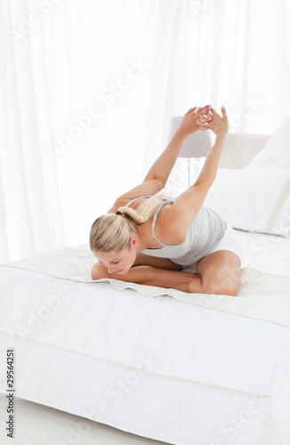 Wallpaper Mural Beautiful woman practicing yoga on her bed Torontodigital.ca