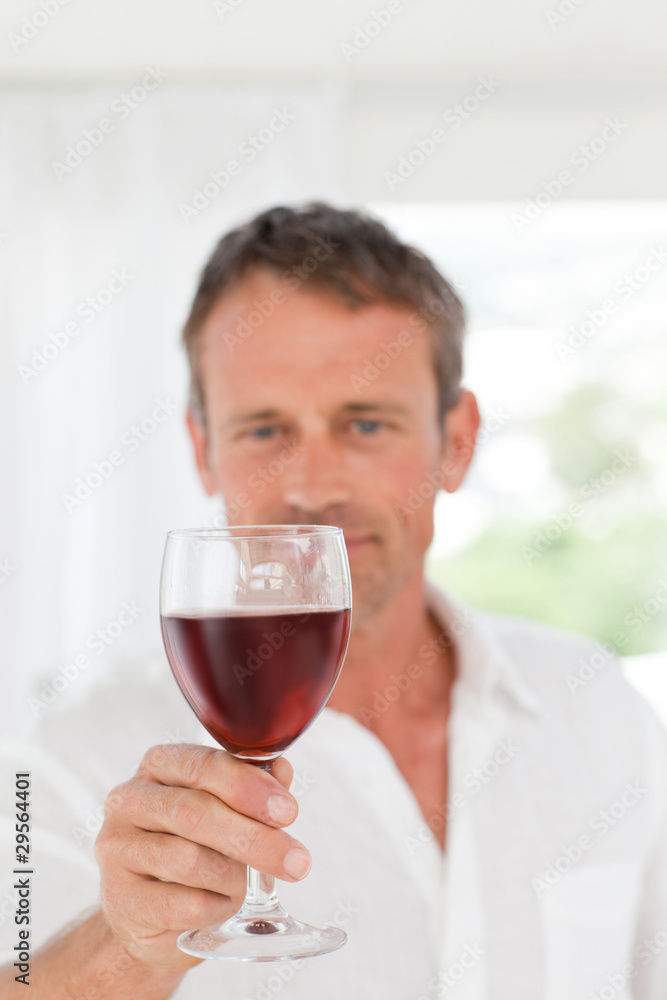 Man with his wineglass in his kitchen Man with his wineglass in his kitchen