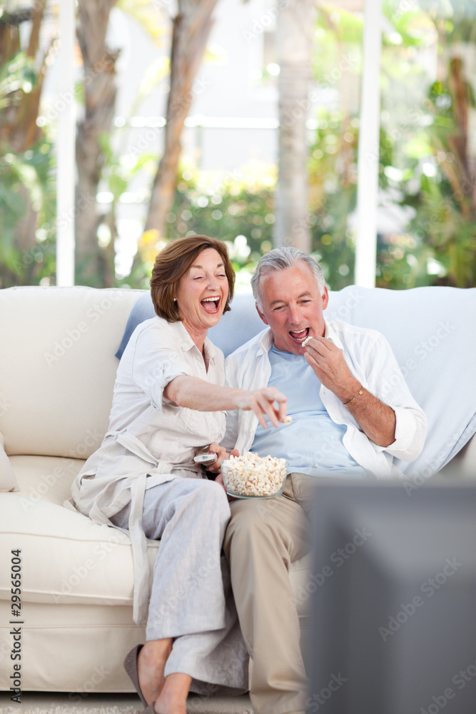 Seniors watching tv at home
