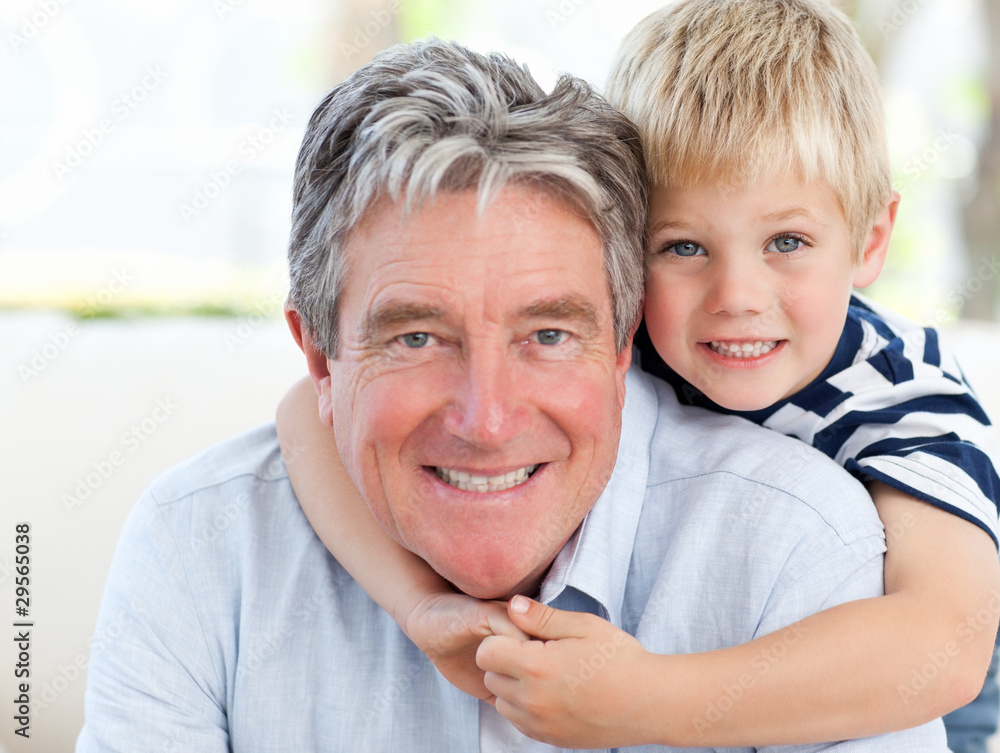 Little boy with his grandfather looking at the camera Little boy with his grandfather looking at the camera