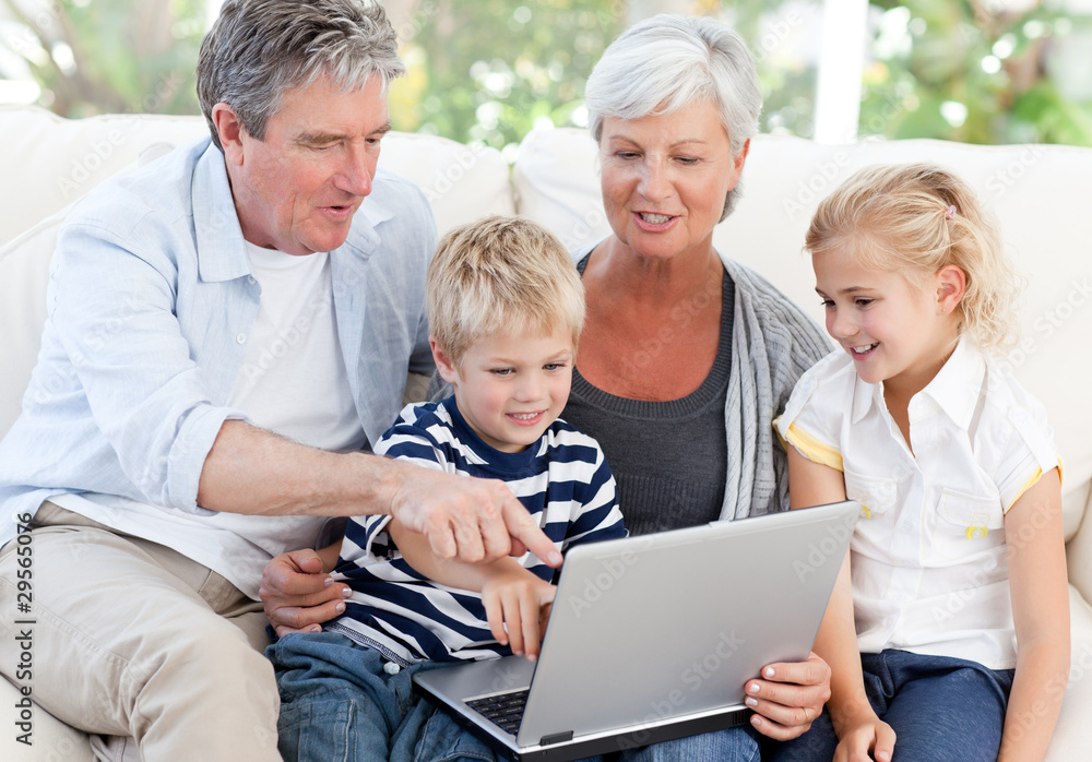 Adorable family looking at their laptop Adorable family looking at their laptop