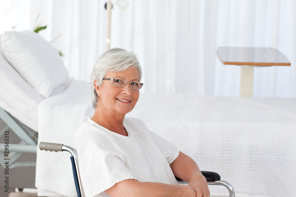Fototapeta premium Senior woman in her wheelchair looking at the camera