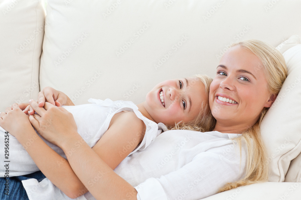 Beautiful woman lying down with her daughter Beautiful woman lying down with her daughter