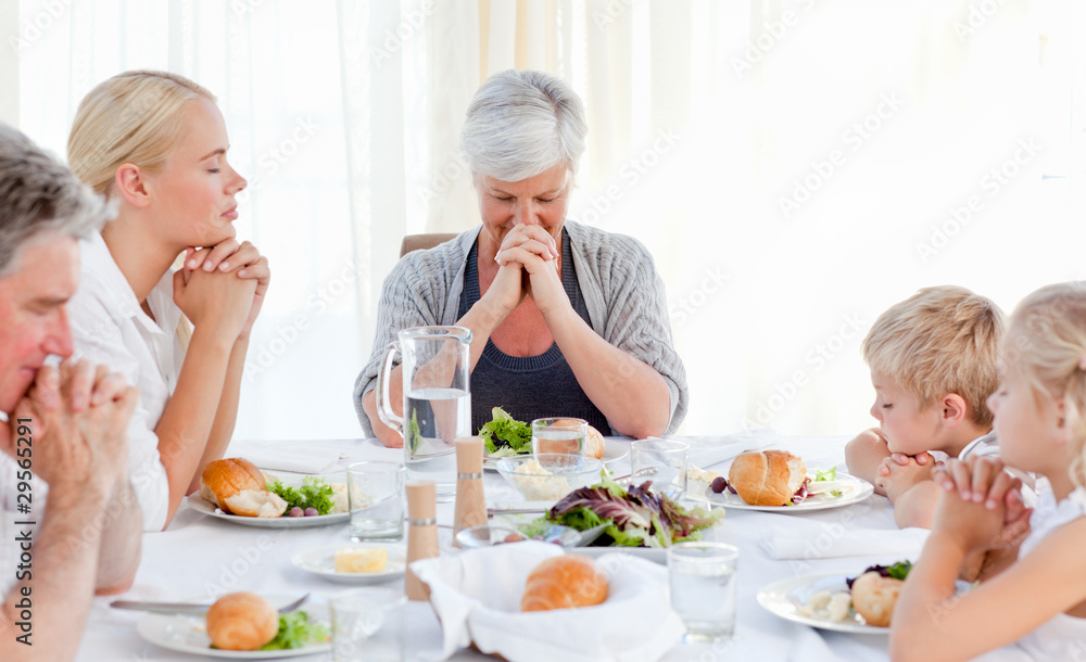 Pretty family praying at the table Pretty family praying at the table