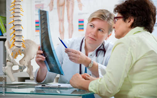 Doctor explaining x-ray results to patient photo