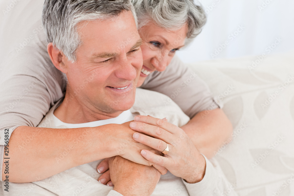 Mature woman hugging her husband Mature woman hugging her husband