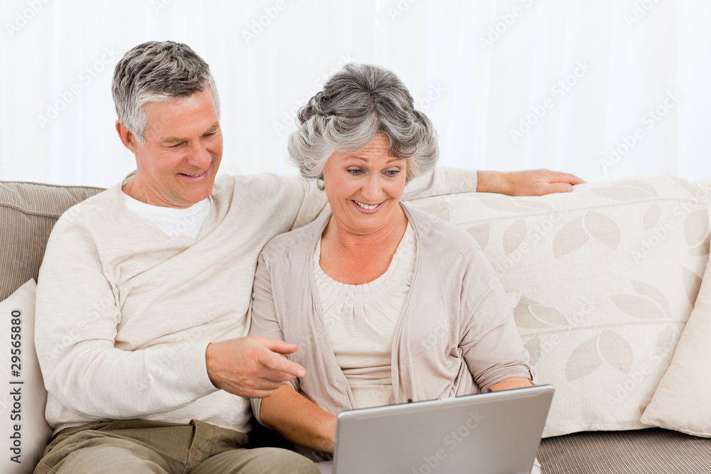 Retired lovers looking at their laptop Retired lovers looking at their laptop
