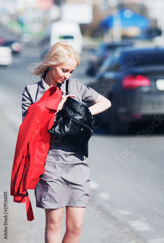 Young businesswoman against a city traffic