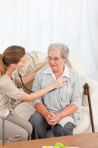 Nurse taking the heartbeat of her patient