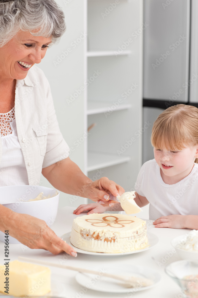 Girl baking with her grandmother at home Girl baking with her grandmother at home