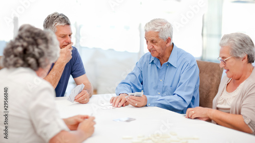 Retired people playing cards together © WavebreakMediaMicro