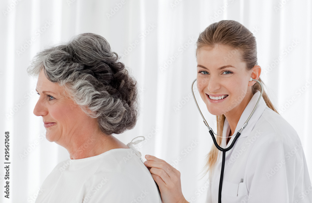 Pretty nurse taking the heartbeat of her patient Pretty nurse taking the heartbeat of her patient