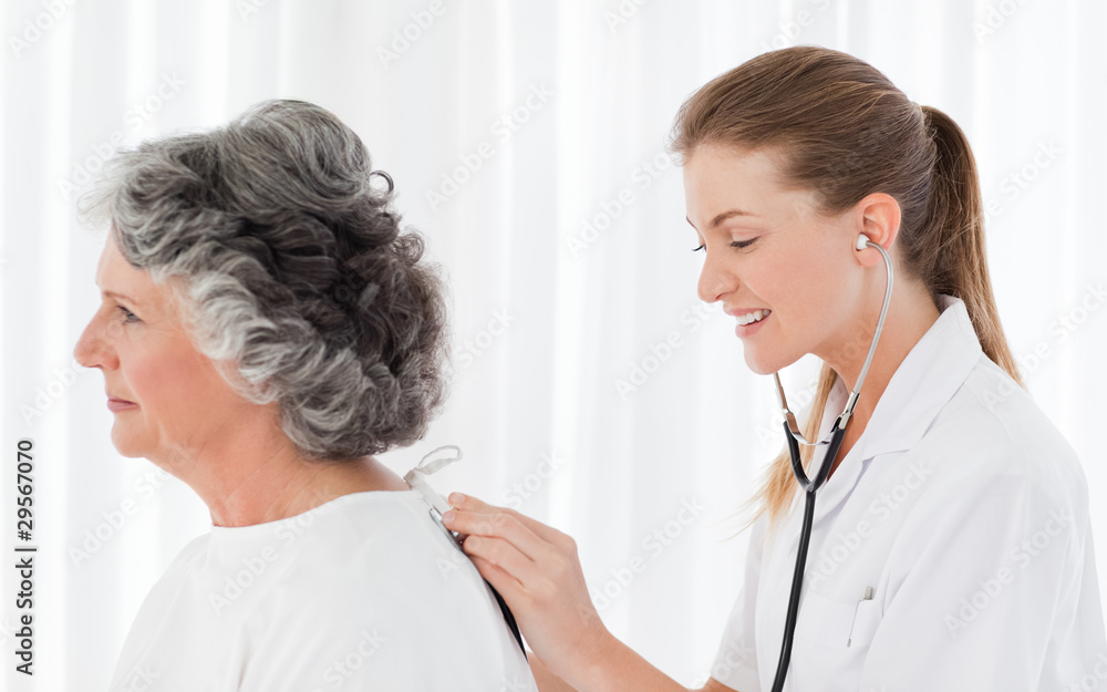 Pretty nurse taking the heartbeat of her patient Pretty nurse taking the heartbeat of her patient