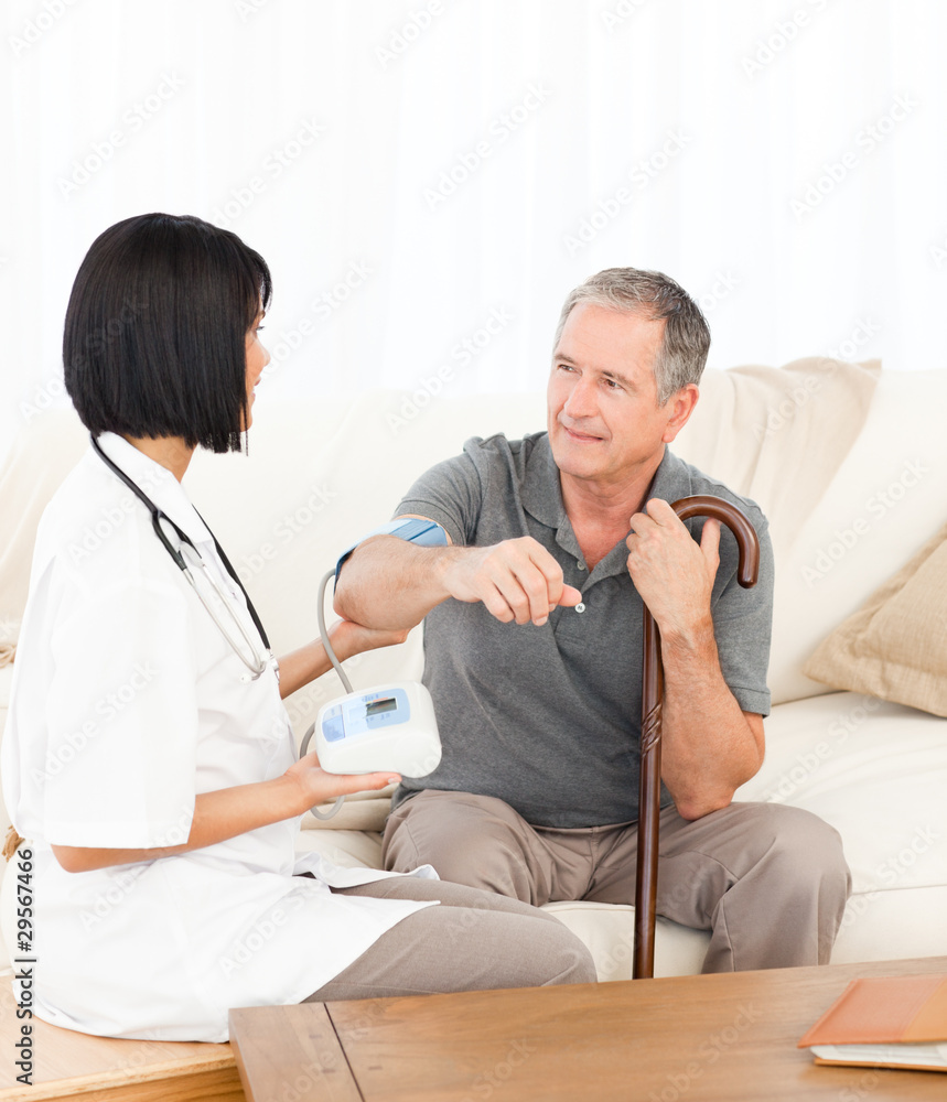 Nurse taking blood pressure of her patient Nurse taking blood pressure of her patient