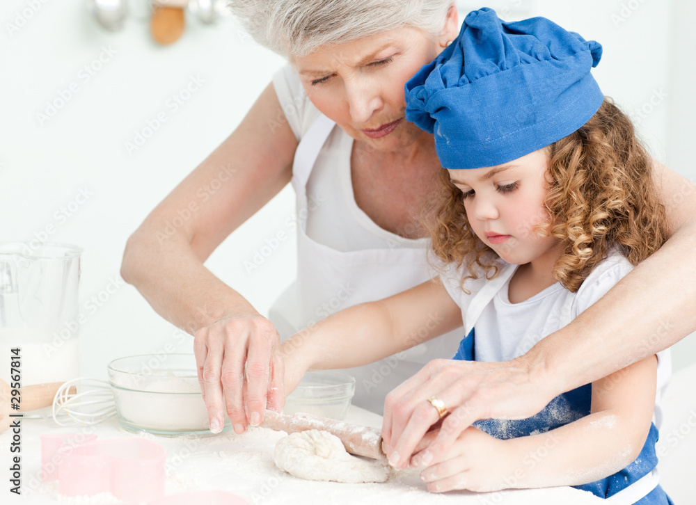 A little girl baking with her grandmother A little girl baking with her grandmother