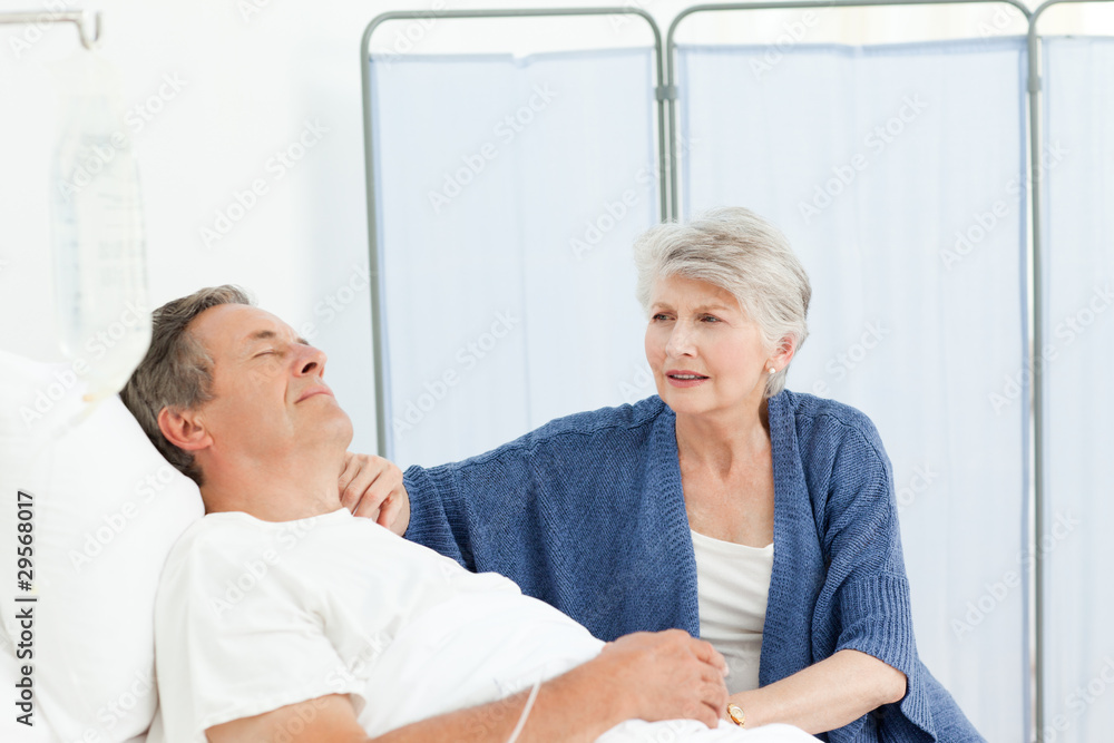 Obraz premium Mature woman taking care of her husband