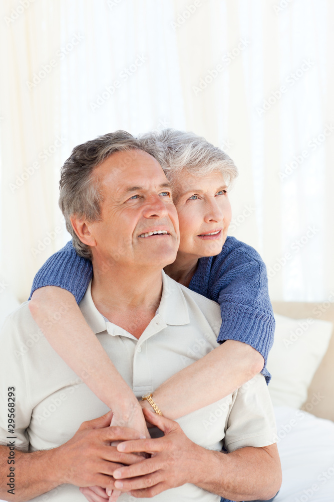 Senior couple hugging on their bed Senior couple hugging on their bed