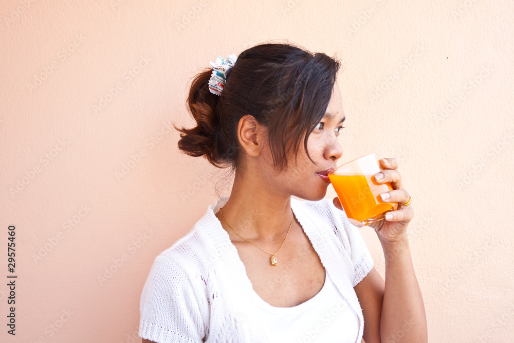 Young woman drinking orange juice