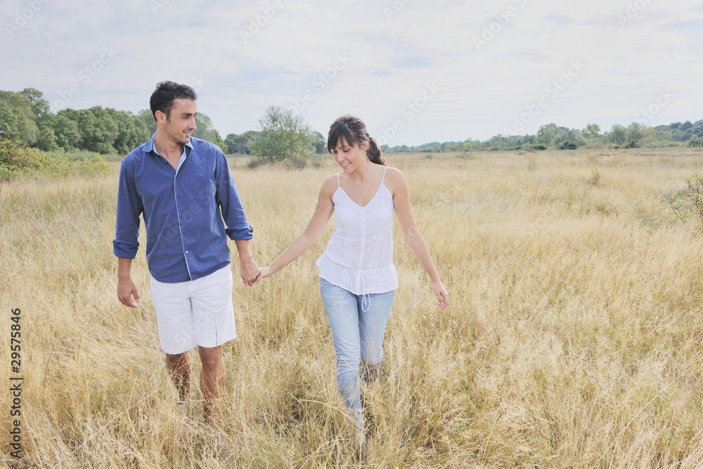 happy couple enjoying countryside picnic in long grass happy couple enjoying countryside picnic in long grass