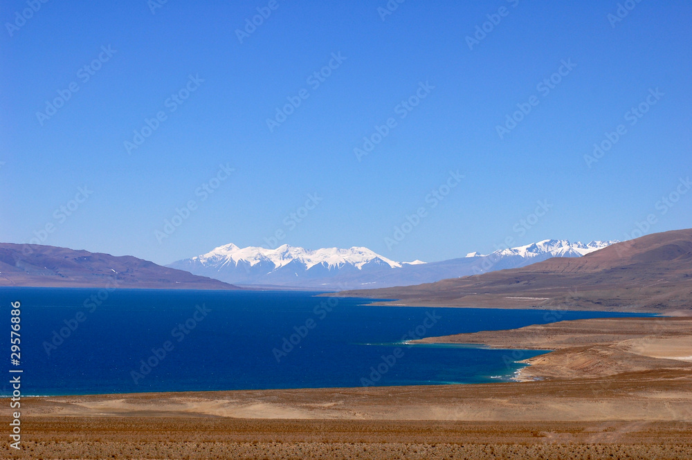 Landscape of blue lake and snow covered mountains