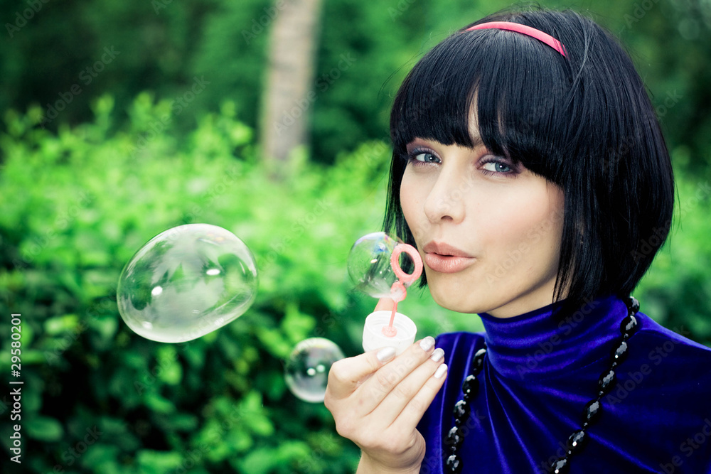 young female makes soap bubbles young female makes soap bubbles