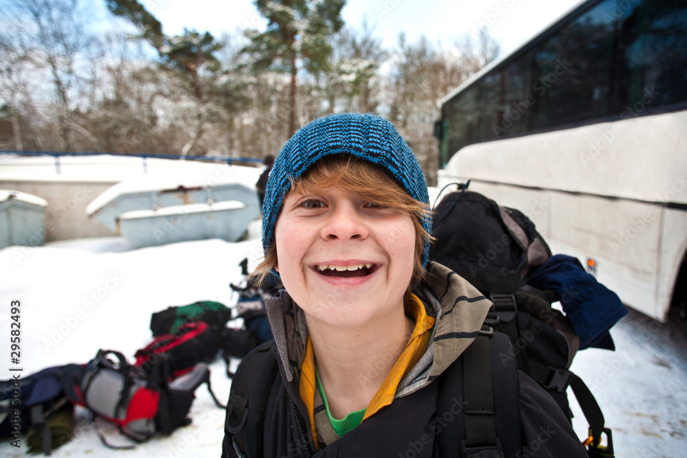 teenager with backpack on a winter trip in snow teenager with backpack on a winter trip in snow