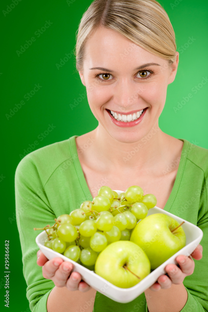 Healthy lifestyle - woman holding bowl with green fruit Healthy lifestyle - woman holding bowl with green fruit