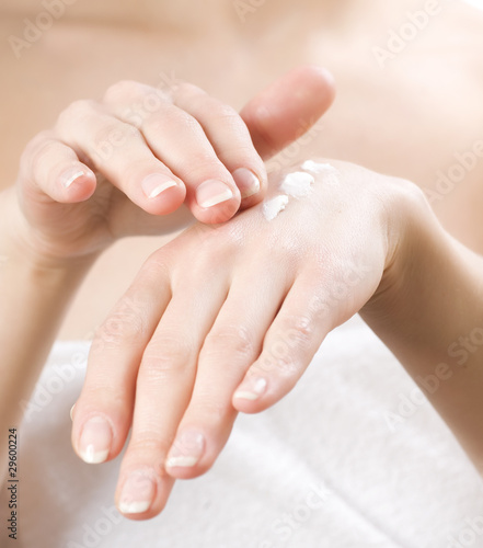 Female applying moisturizer to her Hands © Subbotina Anna