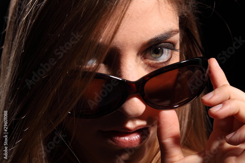 Young woman with sexy look in dark sunglasses
