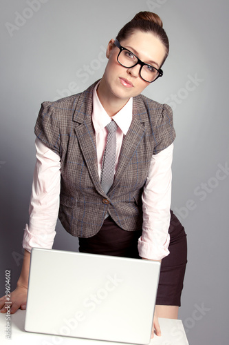 Cute business laby standing by the table photo